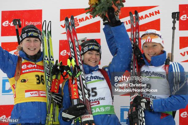 Helena Jonsson of Sweden , Anna Carin Olofsson-Zidek of Sweden and Olga Zaitseva of Russia at the flower ceremony after the women's 7.5 km sprint on...