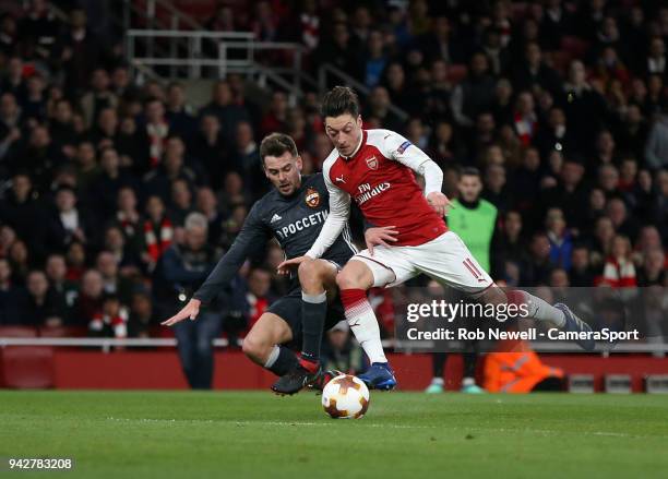 Arsenal's Mesut Ozil is brought down by CSKA Moscow's Georgi Schennikov and earns his side a first half penalty during the UEFA Europa League quarter...