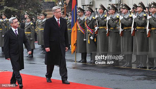Latvian President Valdis Zatlers and his Armenian counterpart Serzh Sarkisian inspect guards of honour during their meeting in Yerevan on December...