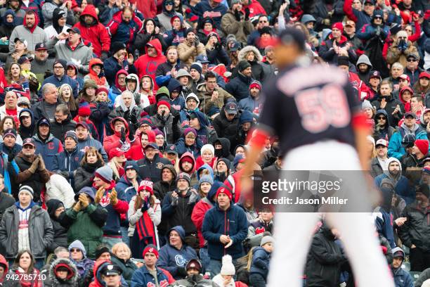Fans cheer on starting pitcher Carlos Carrasco of the Cleveland Indians during the sixth inning against the Kansas City Royals at Progressive Field...