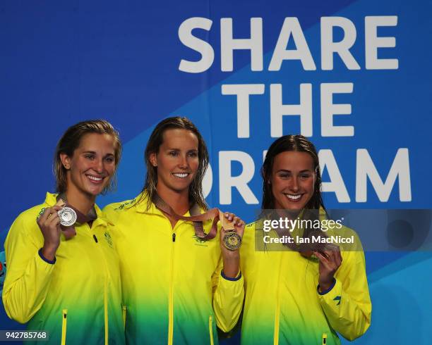 Emma McKeon, Madeline Groves and Brianna Throssell pose with their medals following the Women's 100m Butterfly Final on day two of the Gold Coast...