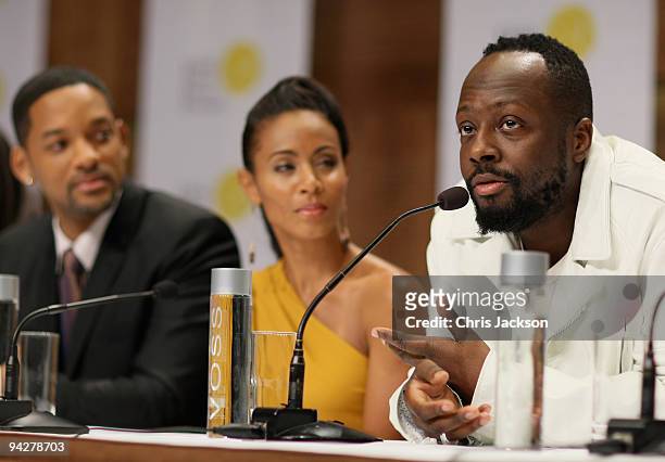 Singer Wyclef Jean talks as actor Will Smith his wife Jada Pinkett Smith listen during a press conference for the Nobel Peace Prize Concert at the...