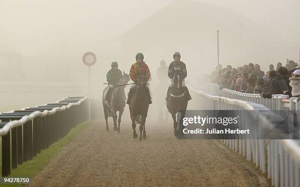 Runners return after The Cheltenham Collection Novices' Steeple Chase Race run at Cheltenham Racecourse on December 11, 2009 in Cheltenham, England.