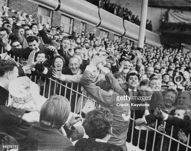 Liverpool centre-forward Ian St John is cheered by fans as he leaves the field after his team beat Chelsea 2-0 in the F.A. Cup semi-final at Villa...