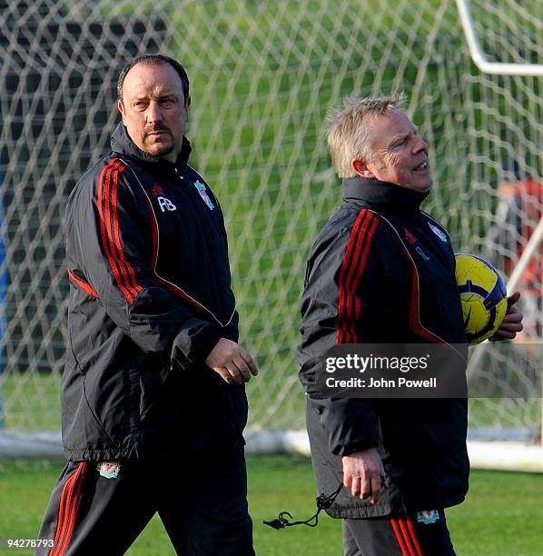 Rafael Benitez manager of Liverpool and his assistant Sammy Lee look on during a team training session at Melwood training ground on December 11,...