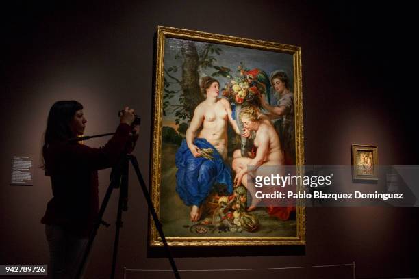 Woman films next to 'Three Nymphs with the Horn of Plenty', 1625-28, by Flemish painter Peter Paul Rubens during the press presentation of 'Rubens....