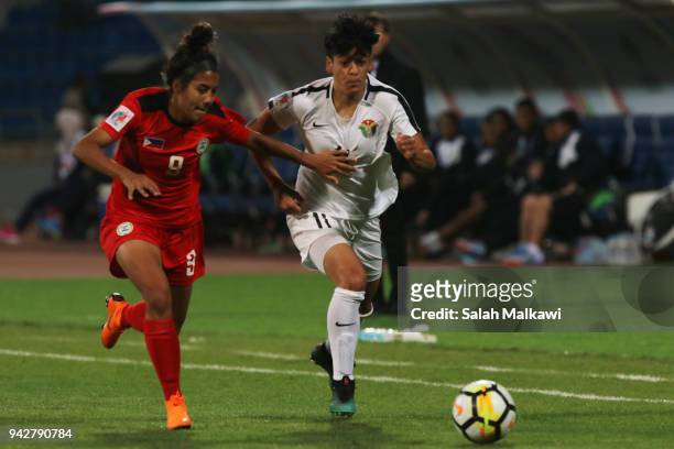 Jesse SHUGG and Quinley QUEZADA of Philippines competes with Maysa JBARAH of Jordan during their match for the AFC Womenâs Asian Cup Jordan 2018, in...
