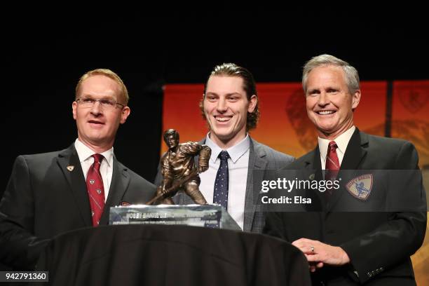 Hobey Baker Chair Peder Melin, award winner Adam Gaudette of Northeastern University and the Vancouver Canucks and announcer Tom Hauser pose with the...