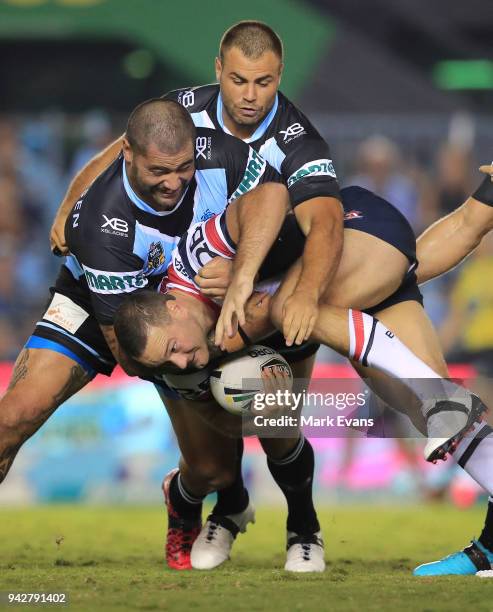 Boyd Cordner of the Roosters is tackled by Andrew Fifita and Wade Graham of the Sharks during the round five NRL match between the Cronulla Sharks...