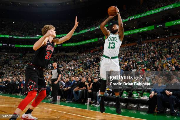 Marcus Morris of the Boston Celtics shoots the ball from downtown during the game against Lauri Markkanen of the Chicago Bulls on April 6, 2018 at...