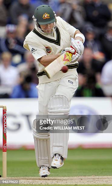 Australian batsman Michael Clarke pulls a balll from the England attack on the third day of the first Ashes cricket Test match in Cardiff, in Wales,...