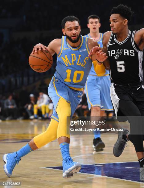 Dejounte Murray of the San Antonio Spurs guards Tyler Ennis of the Los Angeles Lakers as he drives to the basket in the game at Staples Center on...