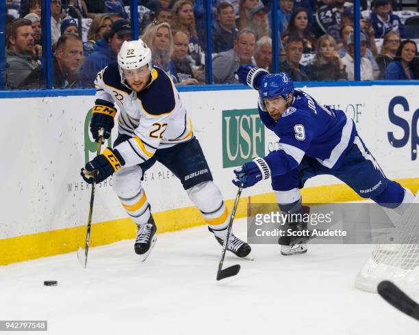 Tyler Johnson of the Tampa Bay Lightning skates against Johan Larsson of the Buffalo Sabres during the first period at Amalie Arena on April 6, 2018...