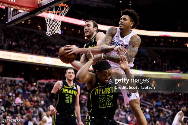 Kelly Oubre Jr. #12 of the Washington Wizards is defended by the Atlanta Hawks during the first half at Capital One Arena on April 6, 2018 in...