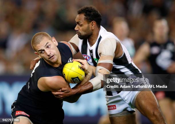 Liam Jones of the Blues is tackled by Travis Varcoe of the Magpies during the 2018 AFL round 03 match between the Carlton Blues and the Collingwood...