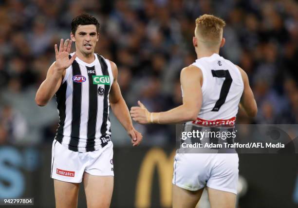 Scott Pendlebury of the Magpies congratulates Adam Treloar of the Magpies on a goal during the 2018 AFL round 03 match between the Carlton Blues and...