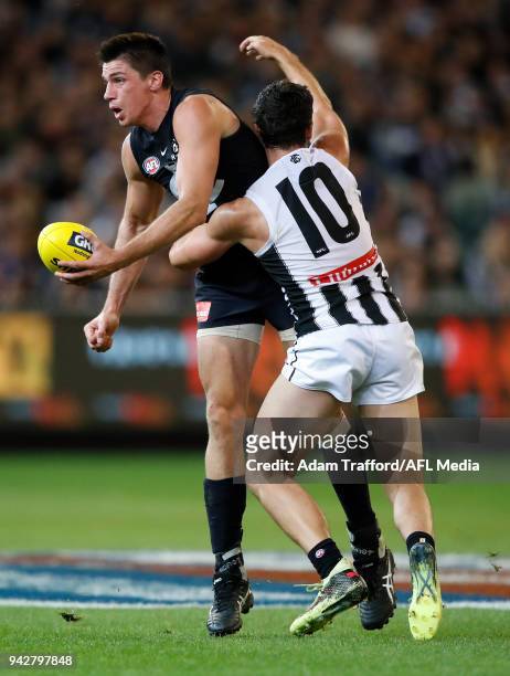Matthew Kreuzer of the Blues is tackled by Scott Pendlebury of the Magpies during the 2018 AFL round 03 match between the Carlton Blues and the...