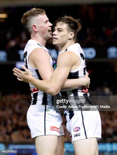 Josh Thomas of the Magpies celebrates a goal with Ben Crocker of the Magpies during the 2018 AFL round 03 match between the Carlton Blues and the...
