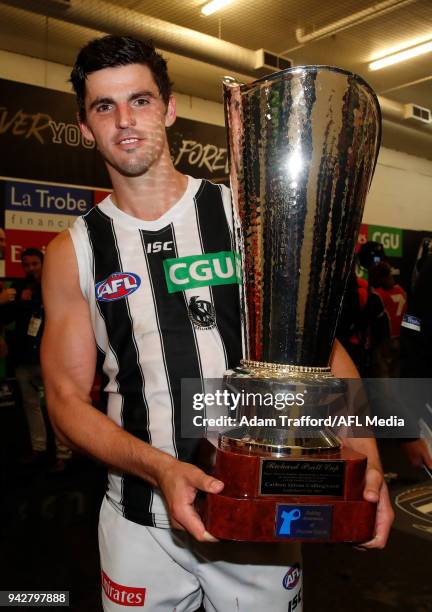 Scott Pendlebury of the Magpies holds the Richard Pratt Cup during the 2018 AFL round 03 match between the Carlton Blues and the Collingwood Magpies...