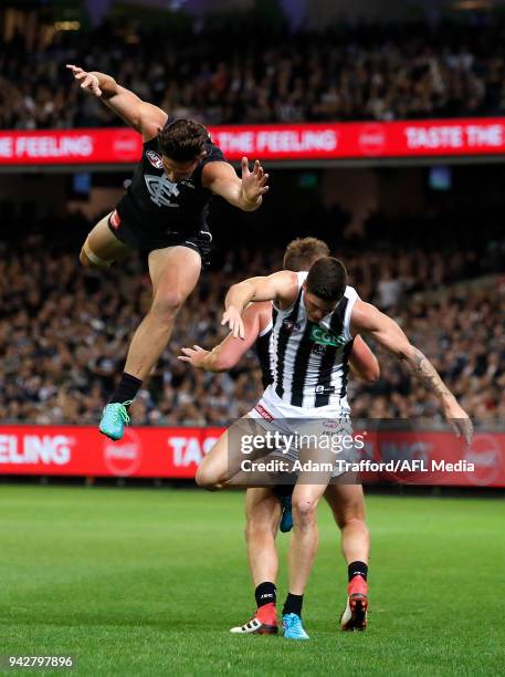 Levi Casboult of the Blues collides with Jack Crisp and Lynden Dunn of the Magpies during the 2018 AFL round 03 match between the Carlton Blues and...