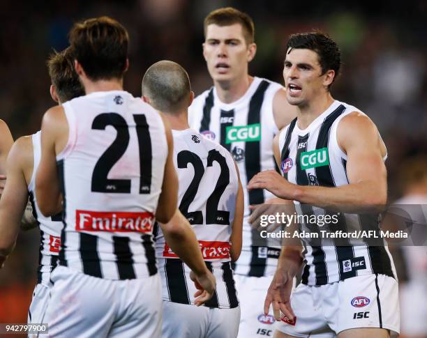 Scott Pendlebury of the Magpies celebrates with teammates during the 2018 AFL round 03 match between the Carlton Blues and the Collingwood Magpies at...