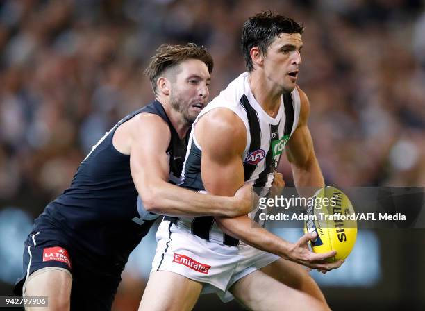 Scott Pendlebury of the Magpies is tackled by Dale Thomas of the Blues during the 2018 AFL round 03 match between the Carlton Blues and the...