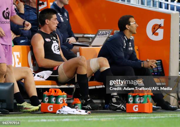 Matthew Kreuzer of the Blues sits on the bench with a groin issue during the 2018 AFL round 03 match between the Carlton Blues and the Collingwood...