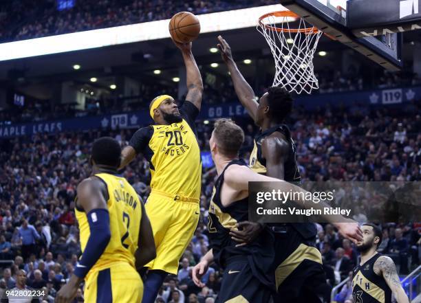 Trevor Booker of the Indiana Pacers shoots the ball as Pascal Siakam and Jakob Poeltl of the Toronto Raptors defend during the first half of an NBA...