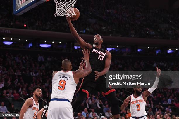 Bam Adebayo of the Miami Heat lays up a shot against Kyle O'Quinn of the New York Knicks during the game at Madison Square Garden on April 6, 2018 in...