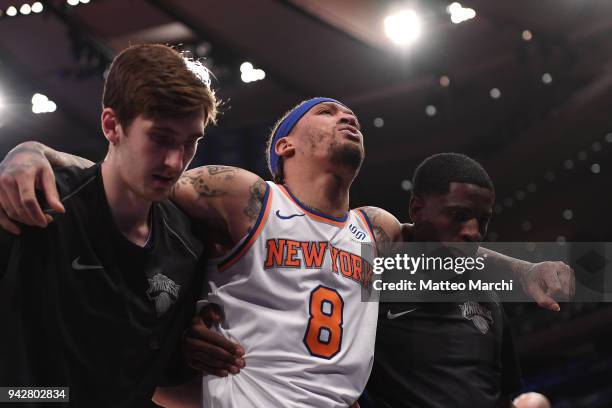 Michael Beasley of the New York Knicks is carried out of the court after getting injured during the game against the Miami Heat at Madison Square...