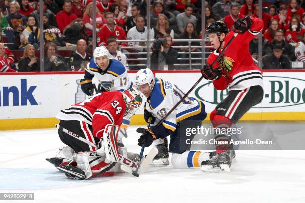 Brayden Schenn of the St. Louis Blues and Connor Murphy of the Chicago Blackhawks battle for the puck in front of goalie J-F Berube in the first...