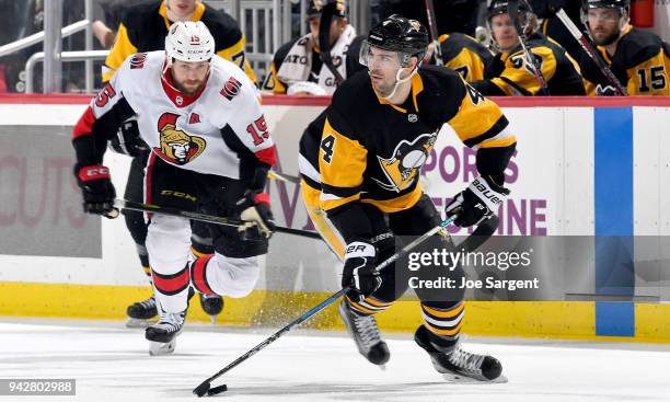 Justin Schultz of the Pittsburgh Penguins handles the puck against Zack Smith of the Ottawa Senators at PPG Paints Arena on April 6, 2018 in...