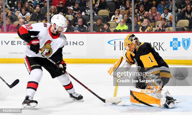 Casey DeSmith of the Pittsburgh Penguins makes a save on Tom Pyatt of the Ottawa Senators at PPG Paints Arena on April 6, 2018 in Pittsburgh,...