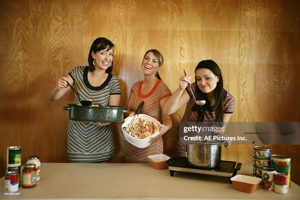 Three girls volunteer at soup kitchen