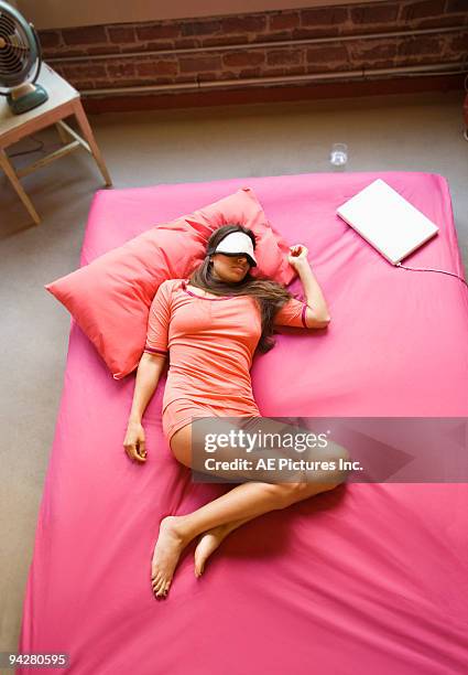 aerial view of woman sleeping - rosa bluse stock-fotos und bilder