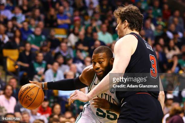 Greg Monroe of the Boston Celtics is guard by Omer Asik of the Chicago Bulls during a game at TD Garden on April 6, 2018 in Boston, Massachusetts....