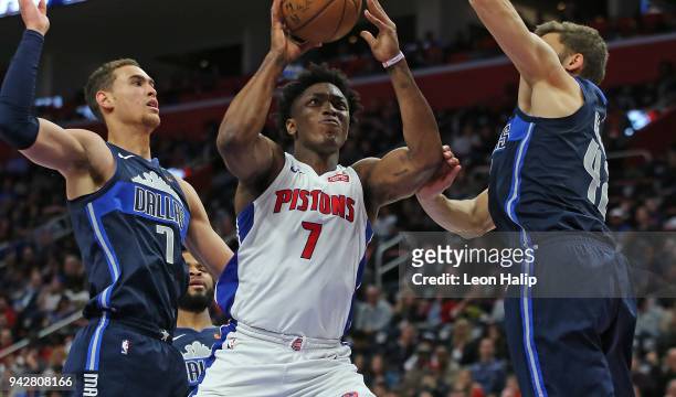 Stanley Johnson of the Detroit Pistons drives the ball to the basket as Dwight Powell and Maximilian Kleber of the Dallas Mavericks defend during the...