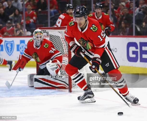 Artem Anisimov of the Chicago Blackhawks clears the puck against the St. Louis Blues at the United Center on April 6, 2018 in Chicago, Illinois.