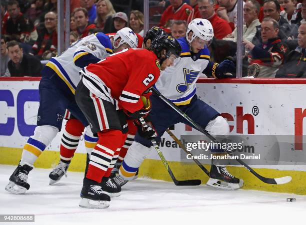 Vladimir Sobotka and Dmitrij Jaskin of the St. Louis Blues move to the puck against Duncan Keith and Artem Anisimov at the United Center on April 6,...