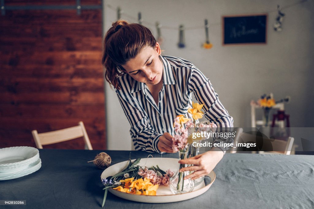 Arranging flowers for dinner table