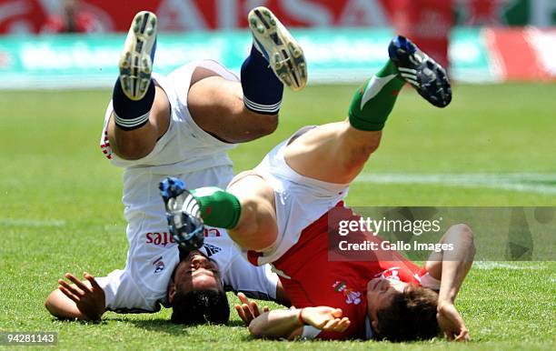 Lloyd Williams of Wales is tackled by Mile Pulu of United States during the IRB Sevens Series match between Wales and United States at Quteniqua Park...