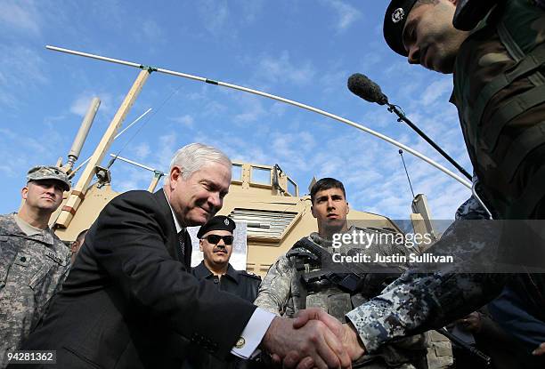 Secretary of Defense Robert Gates greets members of the Iraqi police force at F.O.B. Warrior December 11, 2009 in Kirkuk, Iraq. Secretary Gates...