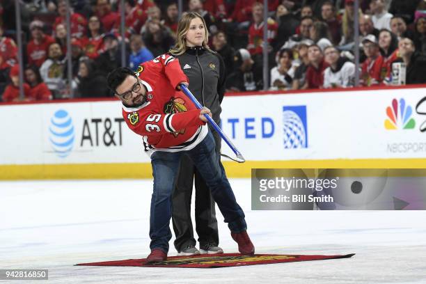 Comedian Horatio Sanz shoots the puck in between periods of the game between the Chicago Blackhawks and the St. Louis Blues at the United Center on...