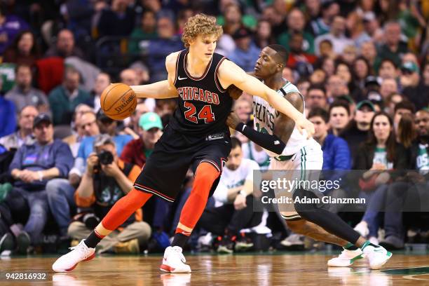 Lauri Markkanen of the Chicago Bulls is guarded by Terry Rozier of the Boston Celtics during a game at TD Garden on April 6, 2018 in Boston,...