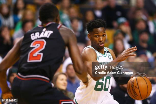 Jonathan Gibson of the Boston Celtics drives to the basket past Jerian Grant of the Chicago Bulls during a game at TD Garden on April 6, 2018 in...