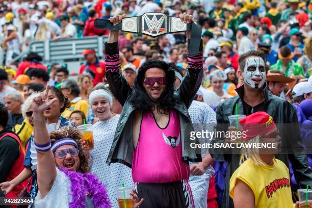 Fans dressed up in costumes pack the South Stand of Hong Kong Stadium early on the second day of the Hong Kong Sevens rugby tournament on April 7,...
