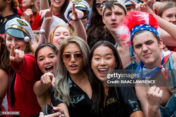 Fans dressed up in costumes pack the South Stand of Hong Kong Stadium early on the second day of the Hong Kong Sevens rugby tournament on April 7,...