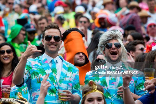 Fans dressed up in costumes pack the South Stand of Hong Kong Stadium early on the second day of the Hong Kong Sevens rugby tournament on April 7,...