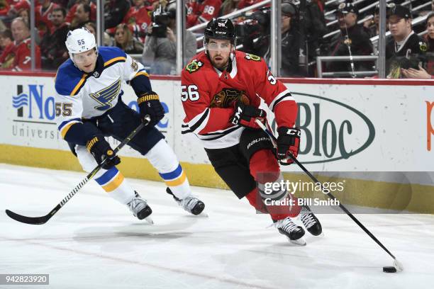 Erik Gustafsson of the Chicago Blackhawks grabs the puck ahead of Colton Parayko of the St. Louis Blues in the third period at the United Center on...