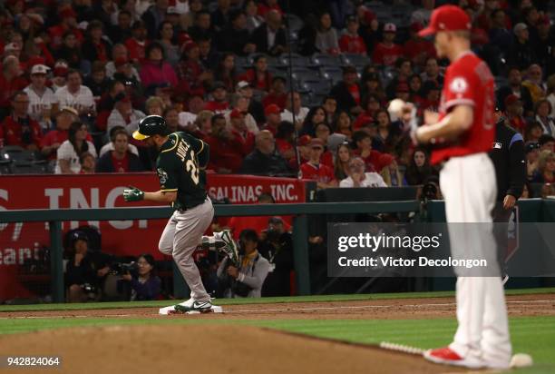 Matt Joyce of the Oakland Athletics rounds third base on his way home after hitting a solo homerun against pitcher Parker Bridwell of the Los Angeles...